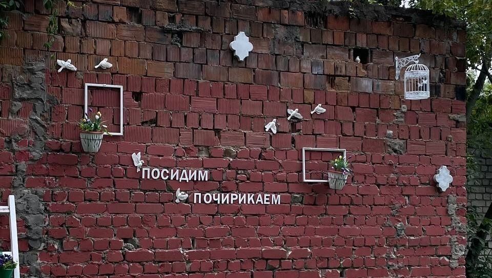 Надпись "Посидим, почирикаем", а под ней - лавочка, куда можно присесть.