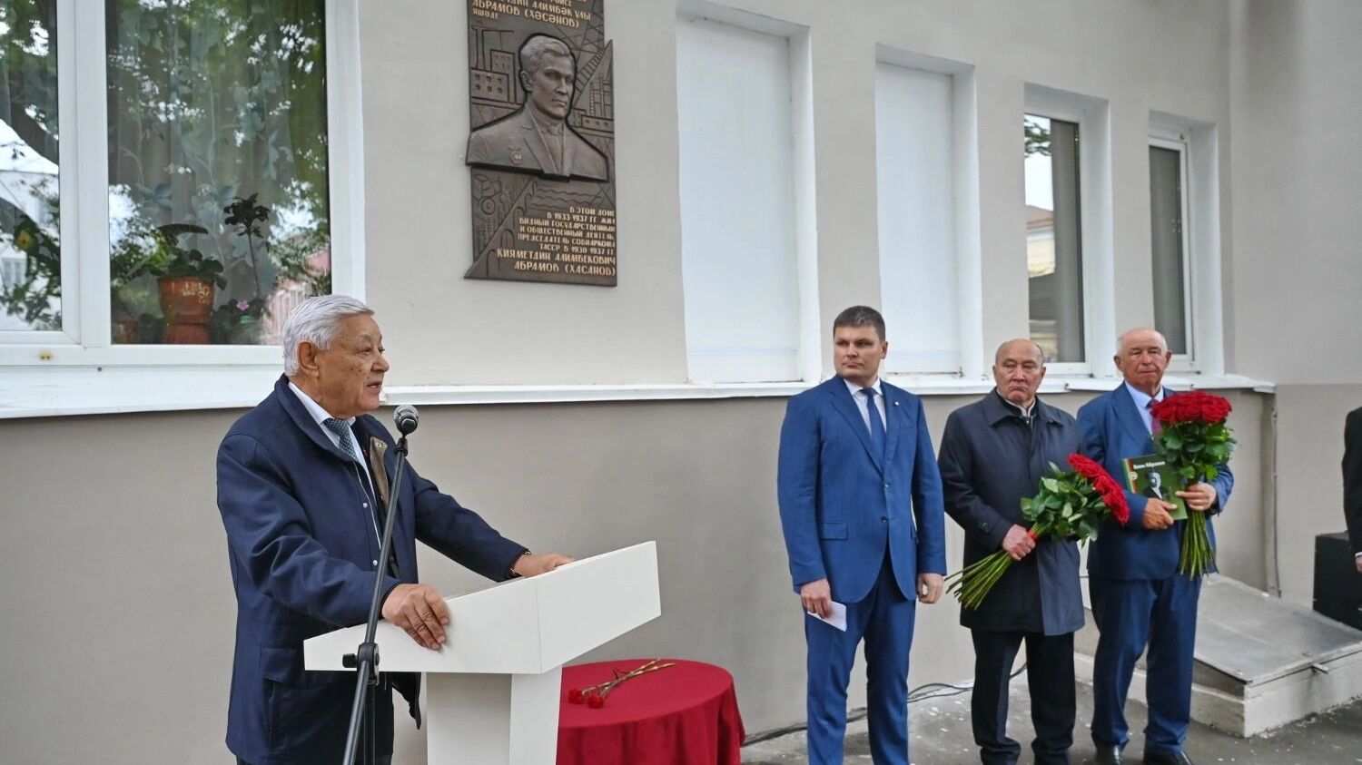 Мухаметшин на фоне памятной доски